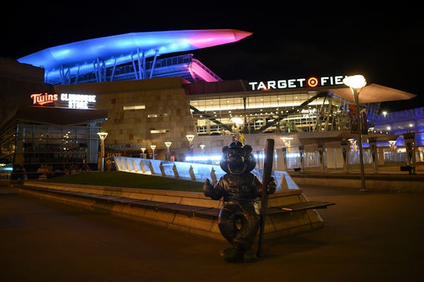 Target Field is lit blue to honor medical and essential workers on the front line of the COVID-19 pandemic, Thursday, April 9, 2020, in Minneapolis. (
