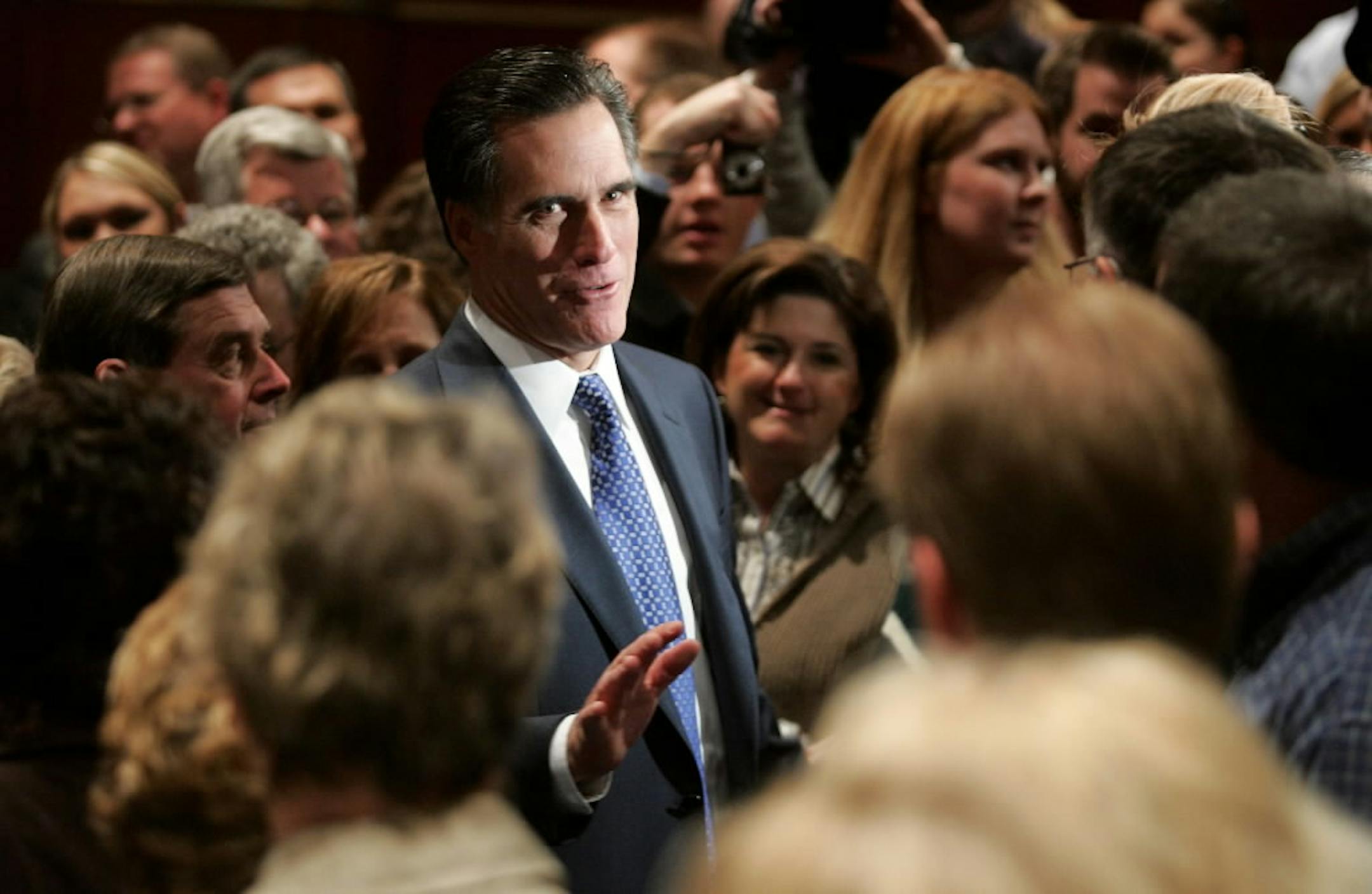 Republican presidential hopeful and former Massachusetts Gov. Mitt Romney talks with staff members of the Principal Financial Group during a caucus day campaign stop in Des Moines.
