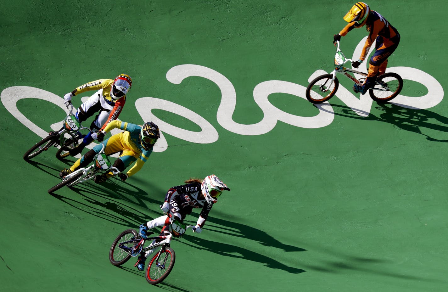 Cyclists, from right, Alise Post of the United States, Lauren Smulders of the Netherlands, Stefany Hernandez of Venezuela and Merle van Benthem of the Netherlands ride during a practice session before the women's seeding run at the Olympic BMX Center during the 2016 Summer Olympics in Rio de Janeiro, Brazil, Wednesday, Aug. 17, 2016. (AP Photo/Pavel Golovkin)