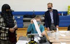 Minnesota Secretary of State Steve Simon visits with poll workers as he toured the Brian Coyle Center, on Election Day Tuesday, Nov. 3, 2020, in Minne