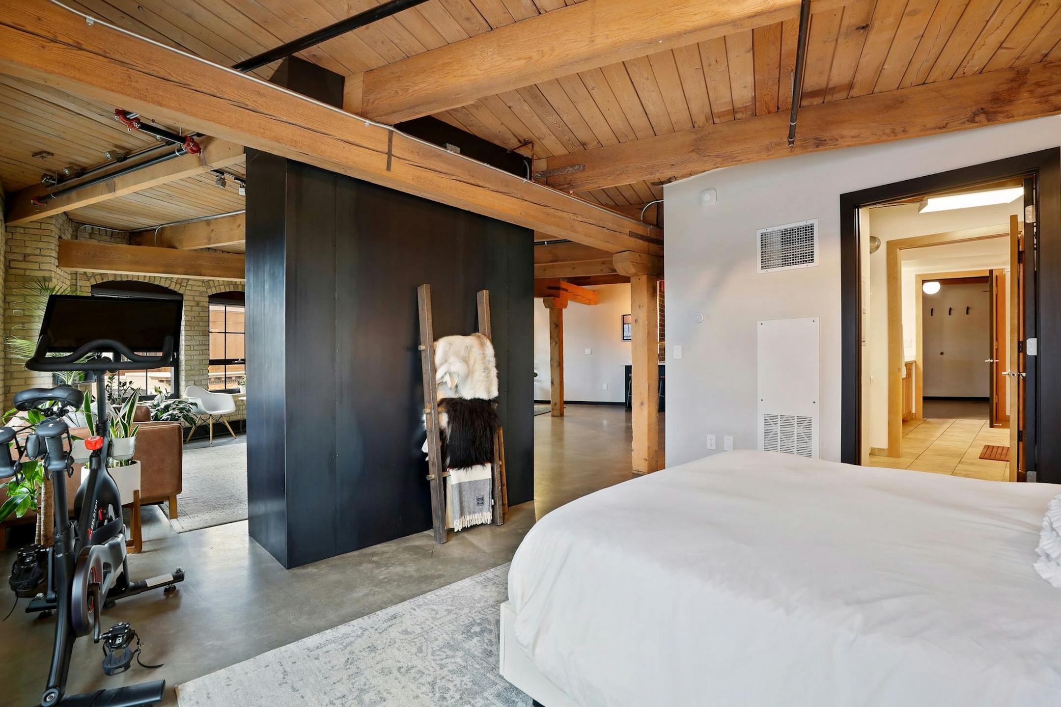 The bedroom. The fireplace is wrapped in hot roll steel.