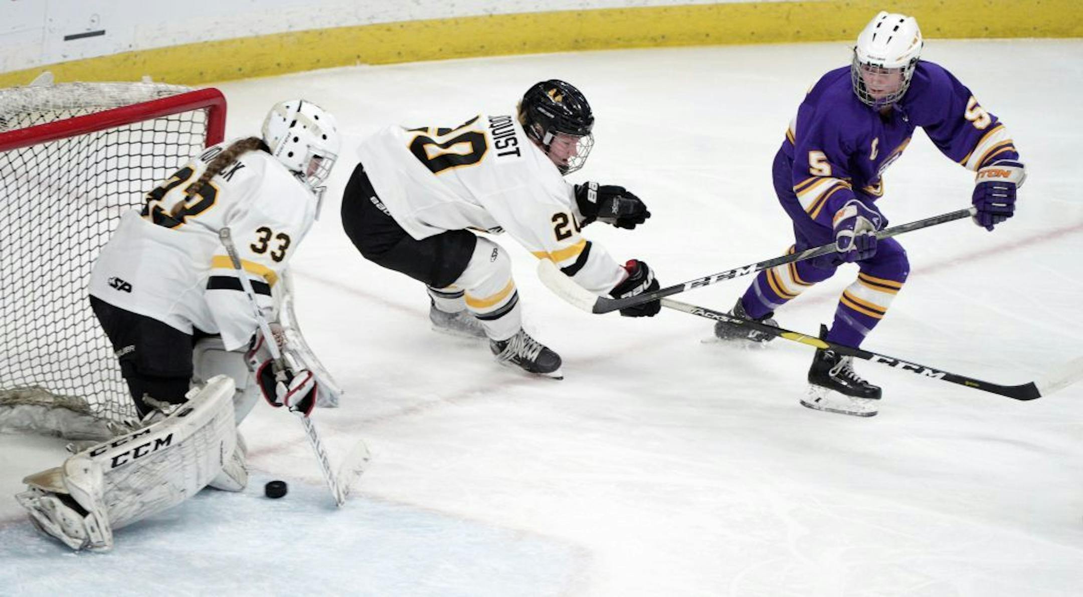 Cloquet's Taylor Nelson slips the puck past Cahllilah Lindquist and under the pads of Warroad goalie CJ Lanctot to score her first of two goals in the first period of the their game.