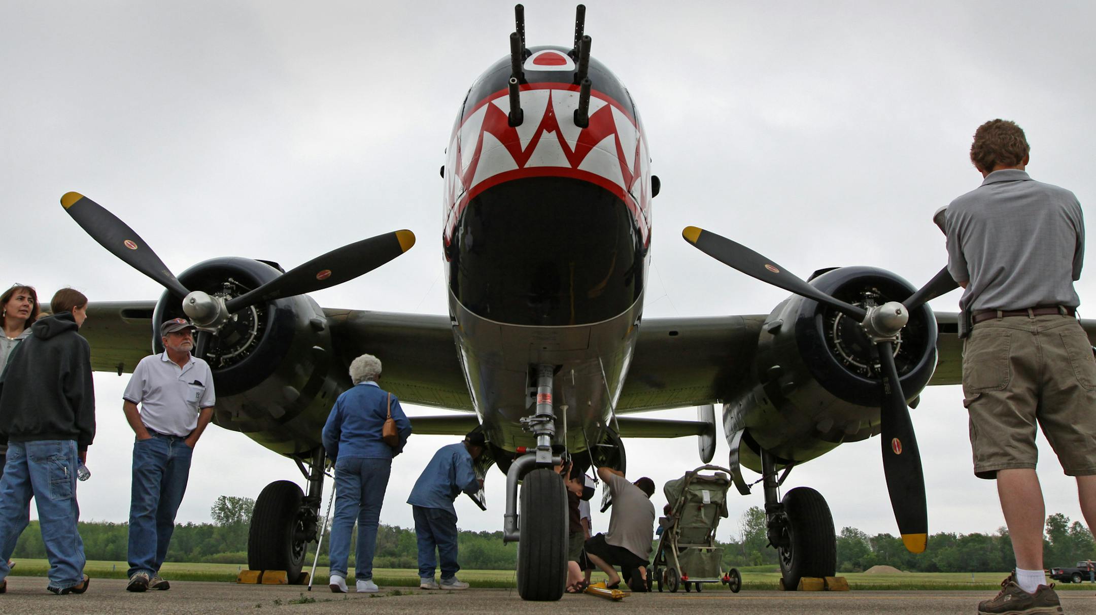 BRUCE BISPING • bbisping@startribune.com Blaine, MN., Saturday, 5/22/2010] (left to right) Aviation fans walked by Betty's Dream, a B-25 Mitchell WW2 bomber during the EAA Chapter #237 Annual Blaine Aviation Weekend at Anoka County Airport. The show features World War Two warbirds, pancake breakfast, a 1940's hanger dance, vintage aircraft displays at the Golden Wings Museum and helicopter rides.