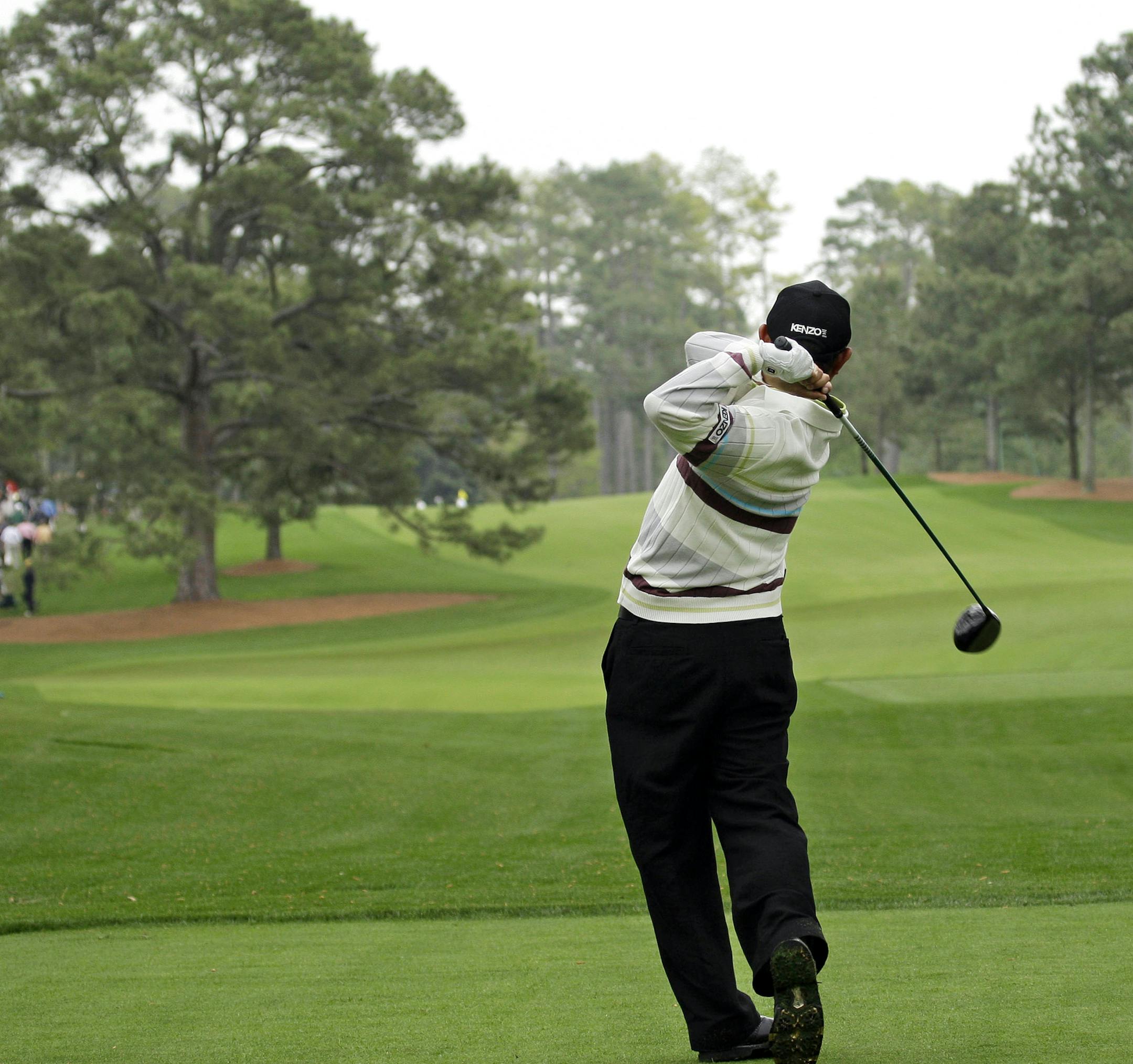 FILE - In this April 8, 2008, file photo, Toru Taniguchi of Japan tees off on the 17th hole of the Augusta National Golf Club, with the Eisenhower Tree at left, during practice for the 2008 Masters golf tournament in Augusta, Ga. The Eisenhower Tree was removed this weekend because of damage from an ice storm, the Augusta National Golf Club chairman Billy Payne said Sunday, Feb. 16, 2014. The loblolly pine was among the most famous trees in golf and it infuriated one of the club members after wh