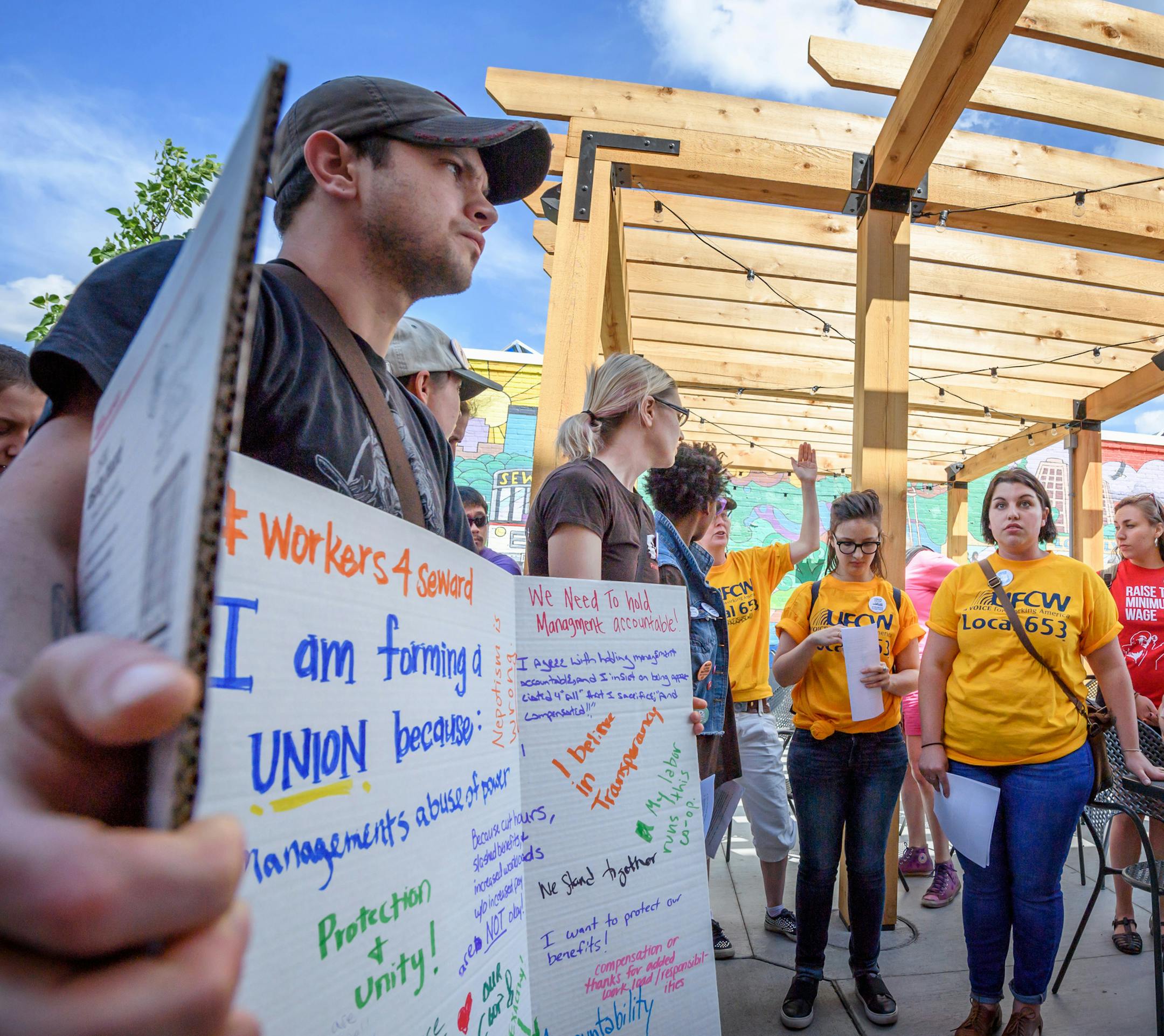 A group of Seward Co-op workers and a allied organizations walked past the Co-op Creamery to Seward Co-op offices and presented their issues to Operations Manager Nick Seeberger, right. ] GLEN STUBBE • glen.stubbe@startribune.com Thursday June 8, 2017 In the largest union effort to organize food coops in Twin Cities history, more than three fourths of about 290 workers employed by a Minneapolis food coop and its three facilities have signed cards asking to be recognized as a union. They h