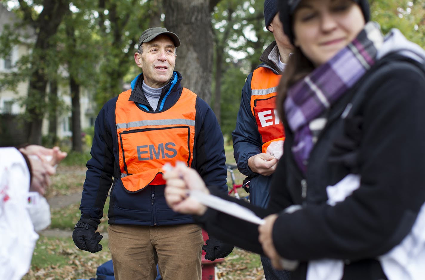 Dr. Jamie Peters coordinates a crew of professionals as they volunteer at a medical station on East River Parkway in Minneapolis during the Twin Cities Marathon October 5, 2014. (Courtney Perry/Special to the Star Tribune)