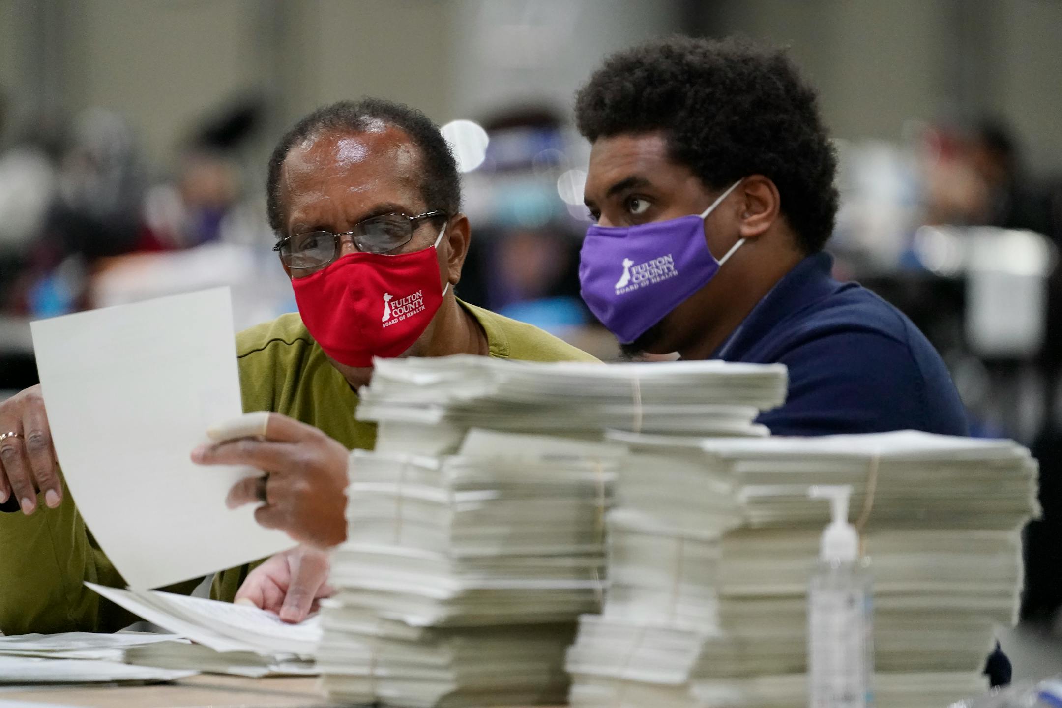 Officials sort ballots during an audit at the Georgia World Congress Center on Nov. 14, 2020, in Atlanta. Election officials in Georgia's 159 counties are undertaking a hand tally of the presidential race that stems from an audit required by state law.