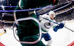 Oscar Fantenberg (5) of the Vancouver Canucks checked Jordan Greenway (18) of the Minnesota Wild in the first period.