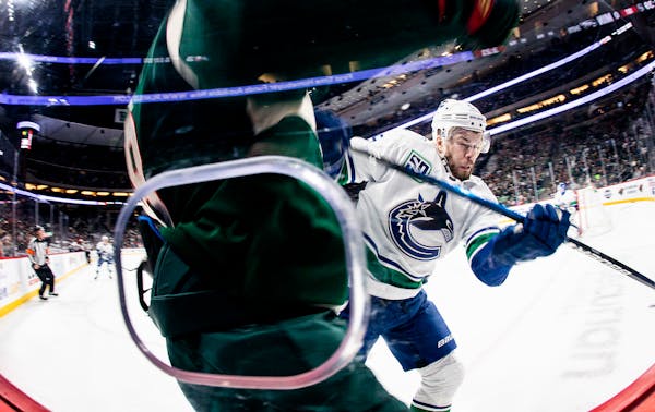 Oscar Fantenberg (5) of the Vancouver Canucks checked Jordan Greenway (18) of the Minnesota Wild in the first period.