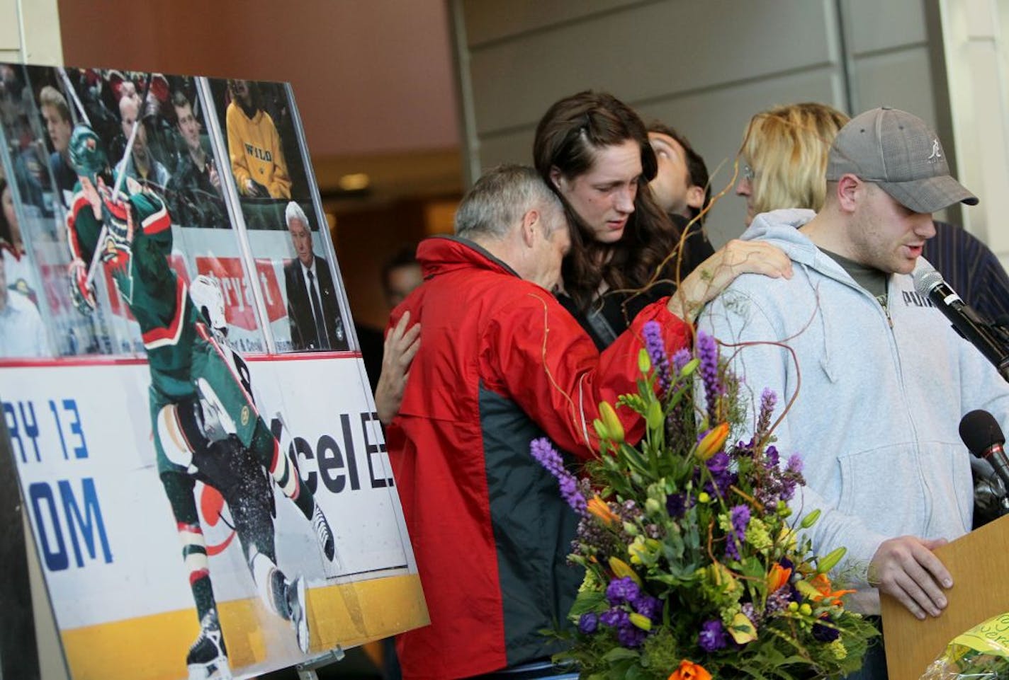 Derek Boogaard's brother, Ryan, spoke during a memorial on Sunday at Xcel Energy Center as his family, including father Len (in red) and sister Krysten, offered support.