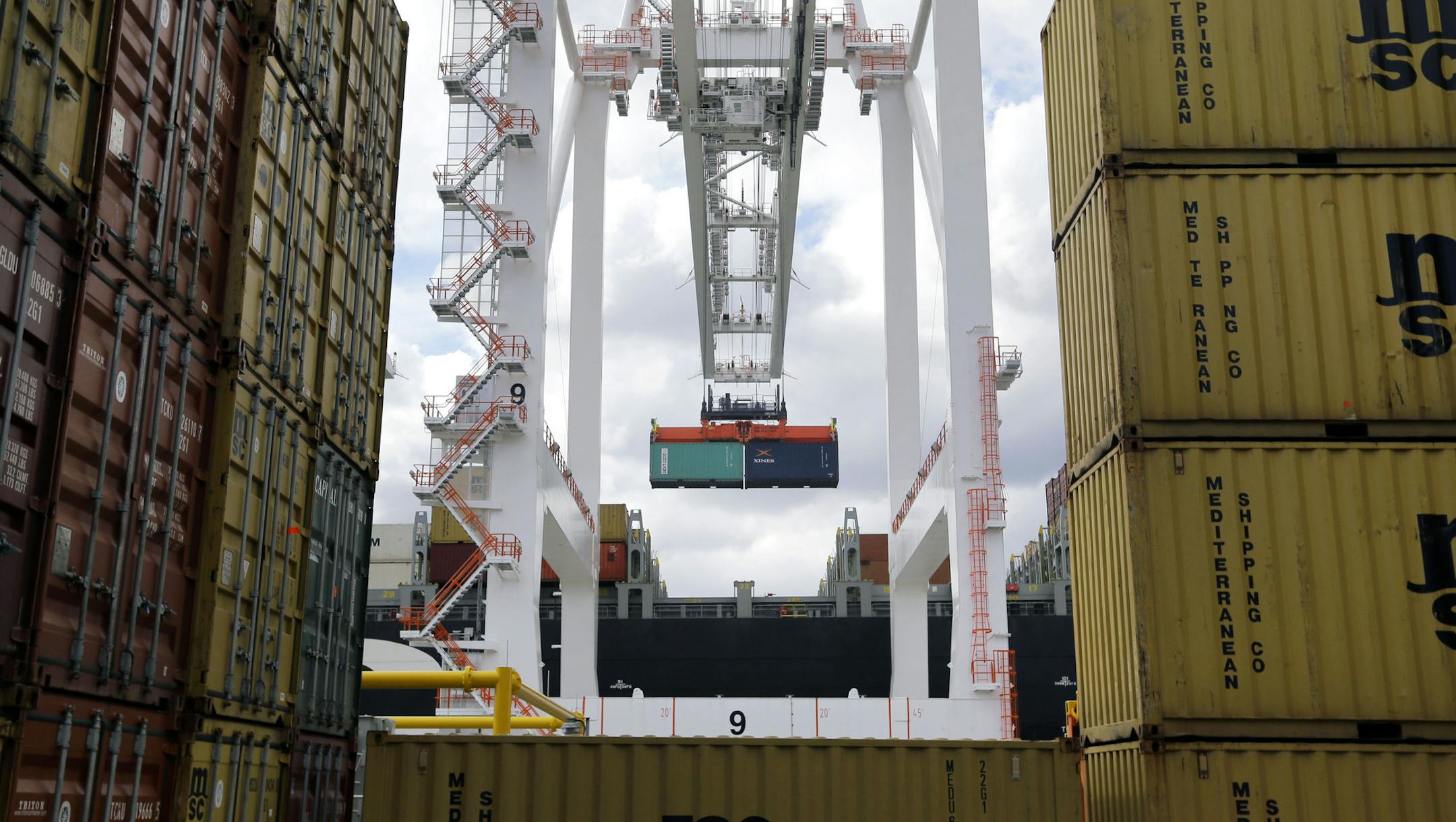 FILE - In this March 1, 2013 file photo, a crane removes a container from a ship at the Port of Baltimore's Seagirt Marine Terminal in Baltimore. The government issues its third and final estimate of economic growth in the January-March quarter, Wednesday, June 26, 2013. (AP Photo/Patrick Semansky, File)