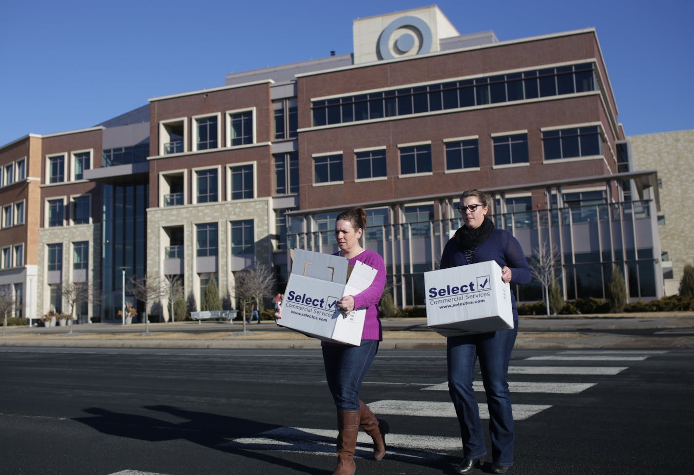 Two Target employees leave the Brooklyn Park Target campus Tuesday morning carrying boxes of belongings. They said they were affected by the layoffs. They did not want to give their names.