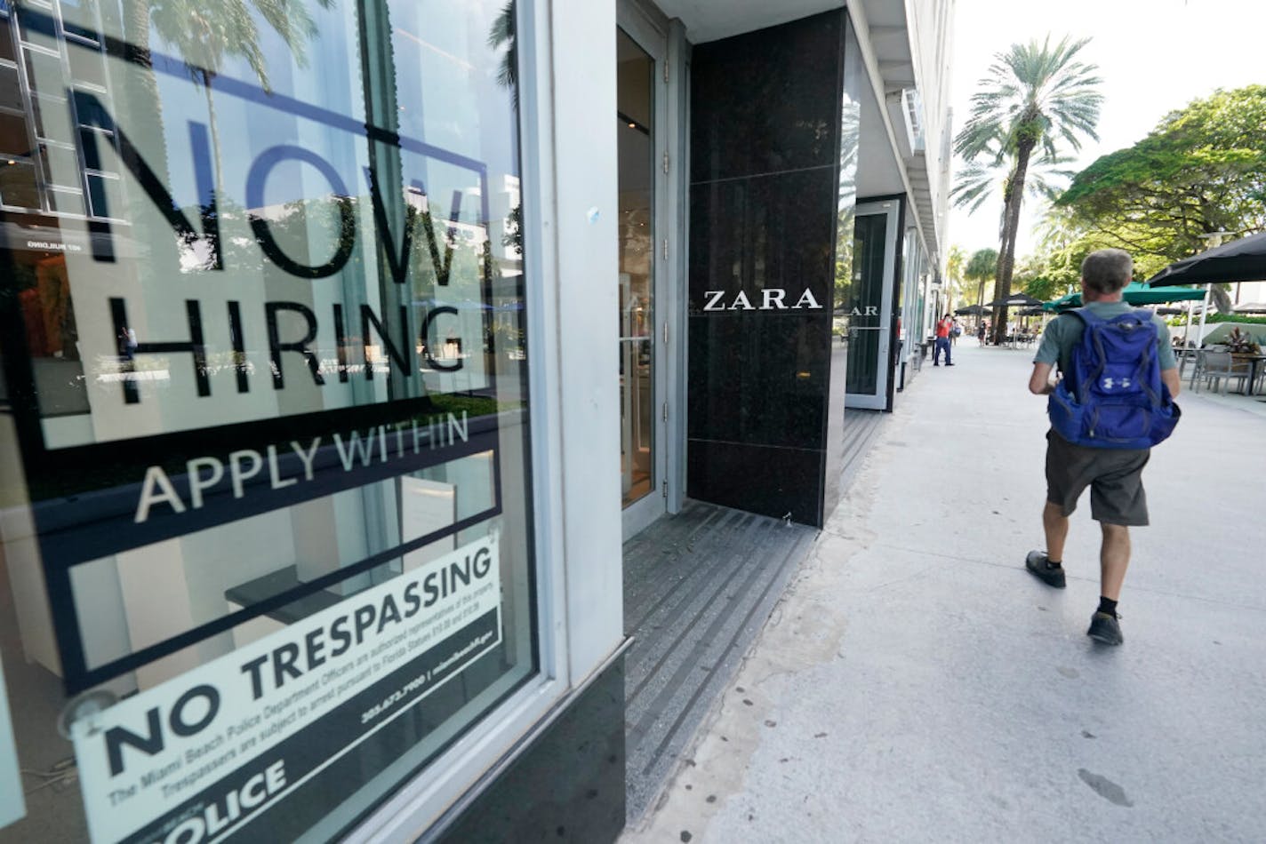 A Zara store posted a large "Now Hiring," sign in its window in Miami Beach, Fla.