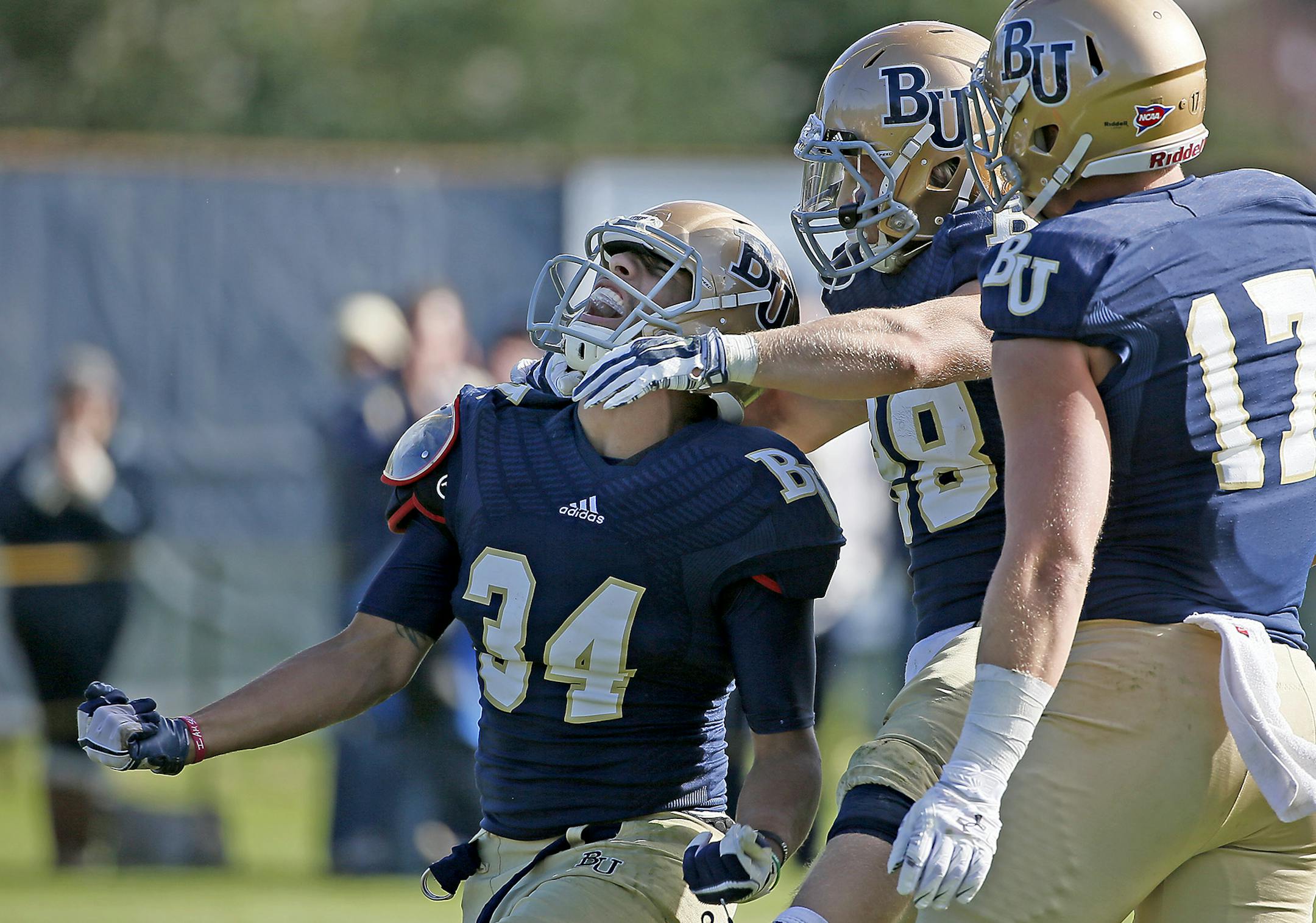 Bethel's Bridgeport Tusler celebrated a touchdown with teammates Marshall Klitzke, center, and Drew Neuville in the fourth quarter as they took on Concordia, Saturday, October 4, 2014 at Bethel University in Arden Hills, MN. Bethel defeated Concordia 27 to 17. ] (ELIZABETH FLORES/STAR TRIBUNE) ELIZABETH FLORES • eflores@startribune.com