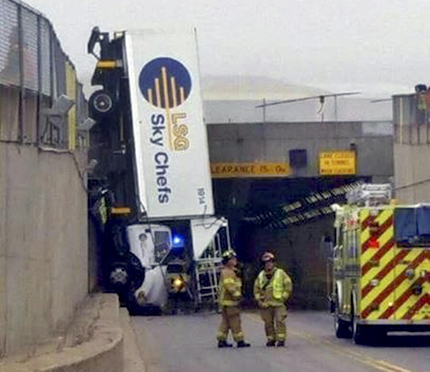 Two people were injured when an airport catering truck went headfirst over a barricade on its way to deliver food to an airplane at Minneapolis-St. Paul International Airport on Sunday morning. No one knows why the truck upended, but it took more than five hours to move the truck into a horizontal position again. The driver and passenger walked out of the van but were taken to the hospital with injuries that weren't life-threatening.