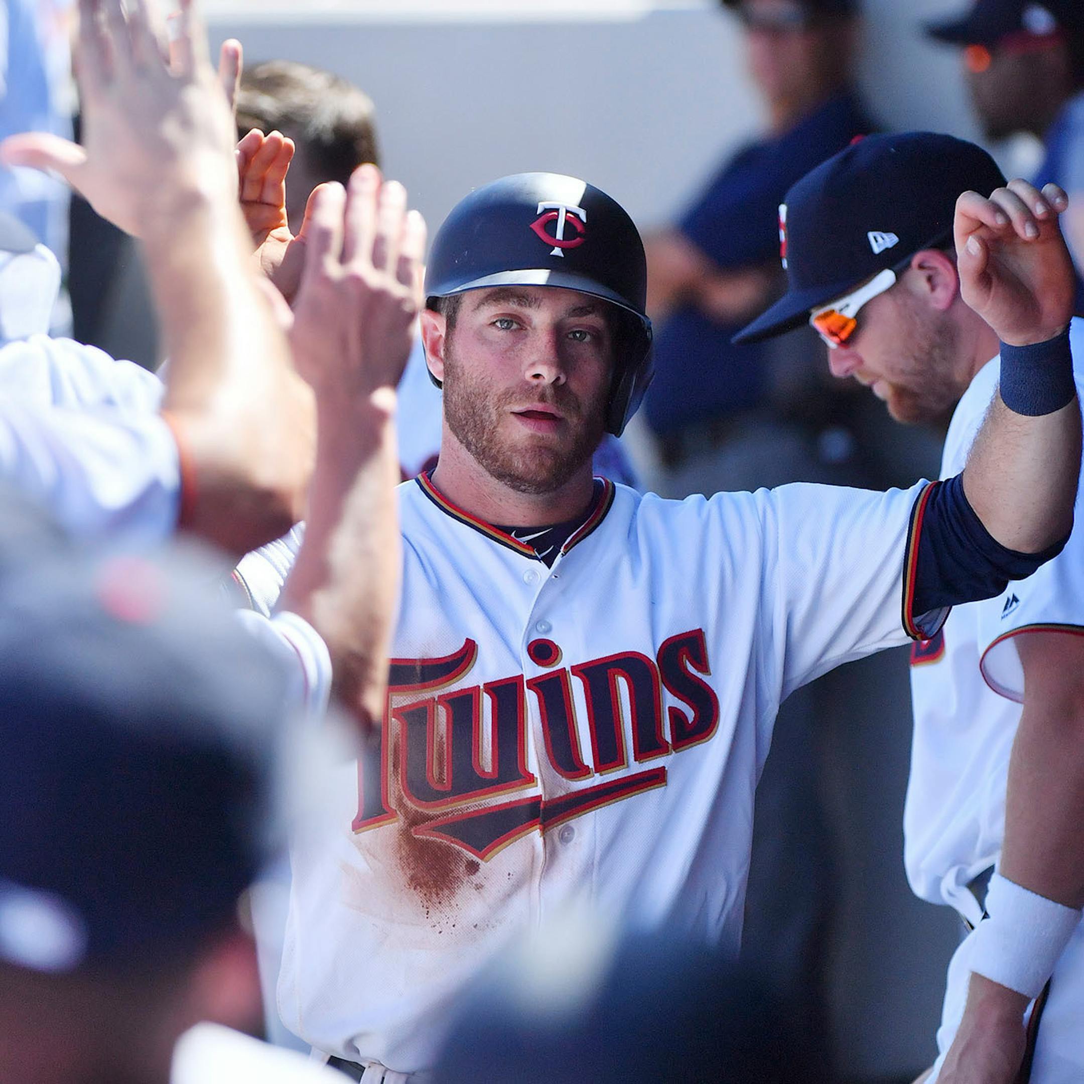 Twins infielder Taylor Featherston (38) scored off a double by Twins second baseman Brian Dozier (2) in the third inning.