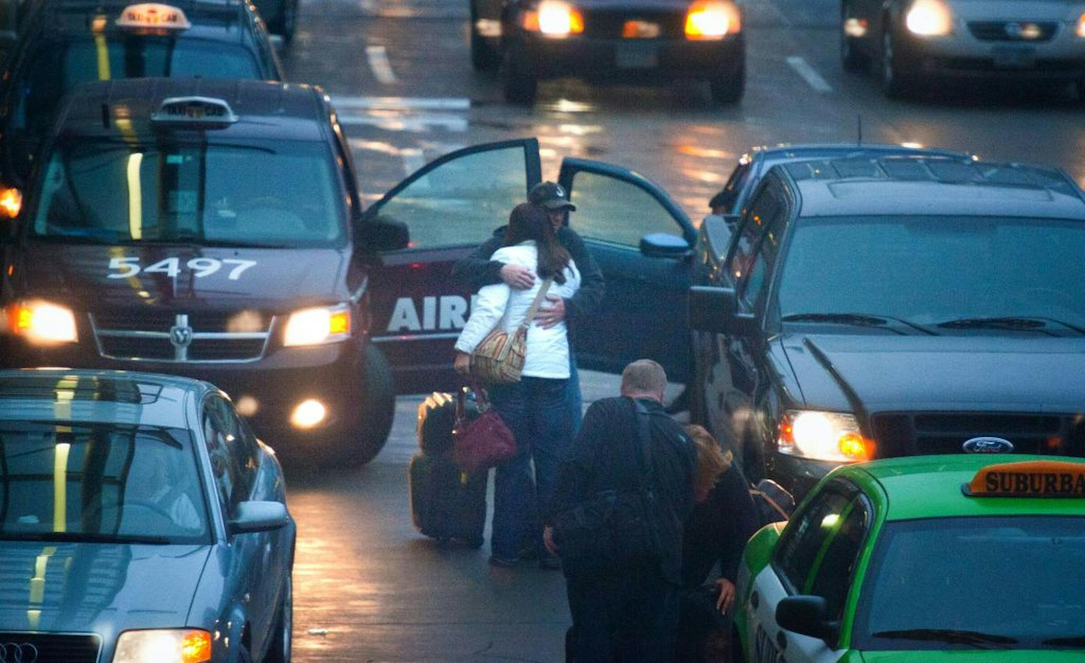 Hugs, kisses and farewell handshakes dotted the curbs at Minneapolis-St. Paul International Airport's main terminal Tuesday evening.