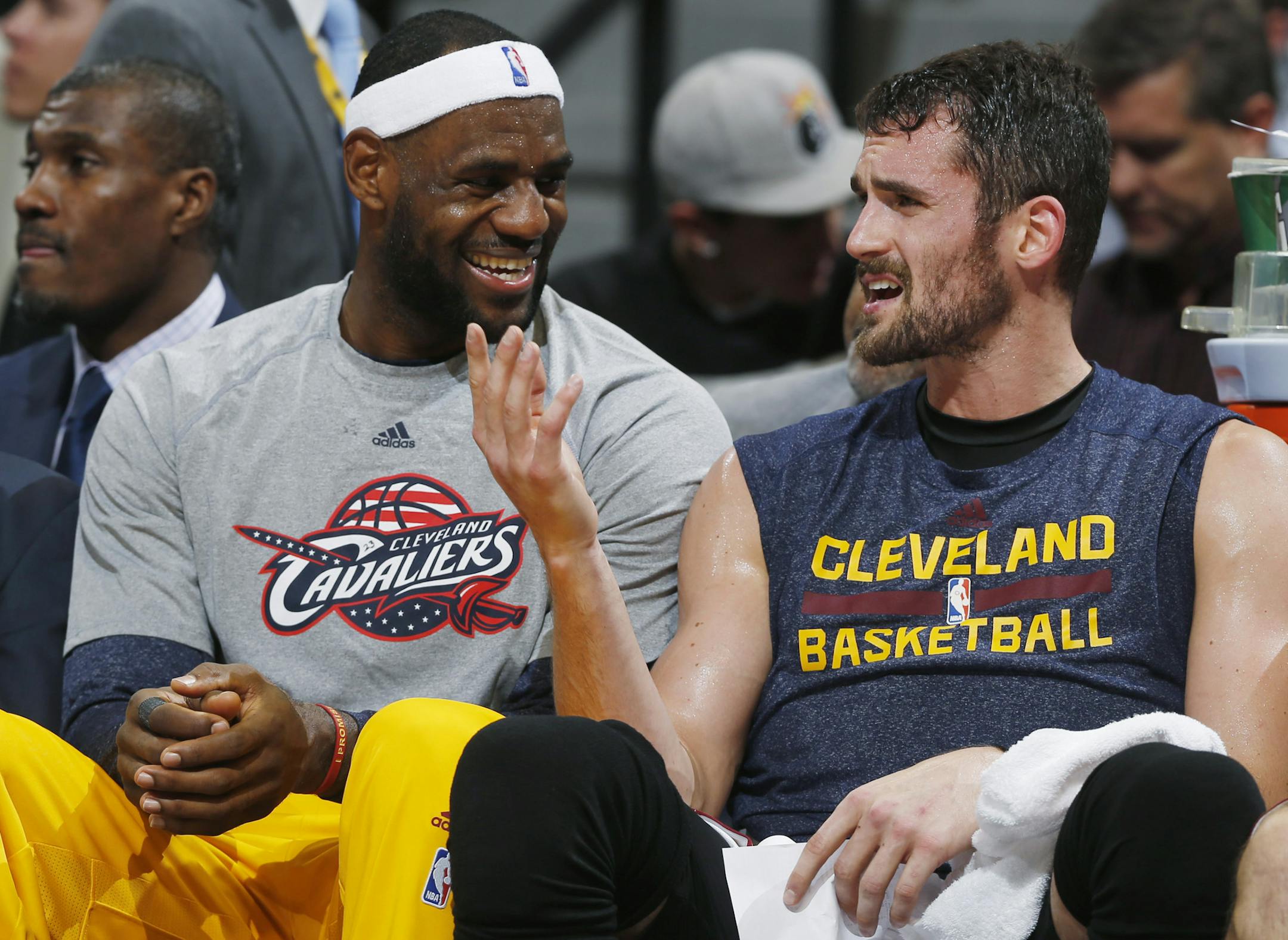 FILE - In this Nov. 7, 2014, file photo, Cleveland Cavaliers forwards LeBron James, left, and Kevin Love joke with each other on the bench in the fourth quarter of the Cavaliers' 110-101 victory over the Denver Nuggets in an NBA basketball game in Denver. Forward Kevin Love says he and superstar LeBron James had a "very honest" talk before he decided to re-sign as a free agent with the Cavaliers. Love announced he was returning last week and said Thursday, July 9, 2015, that his new five-year, $
