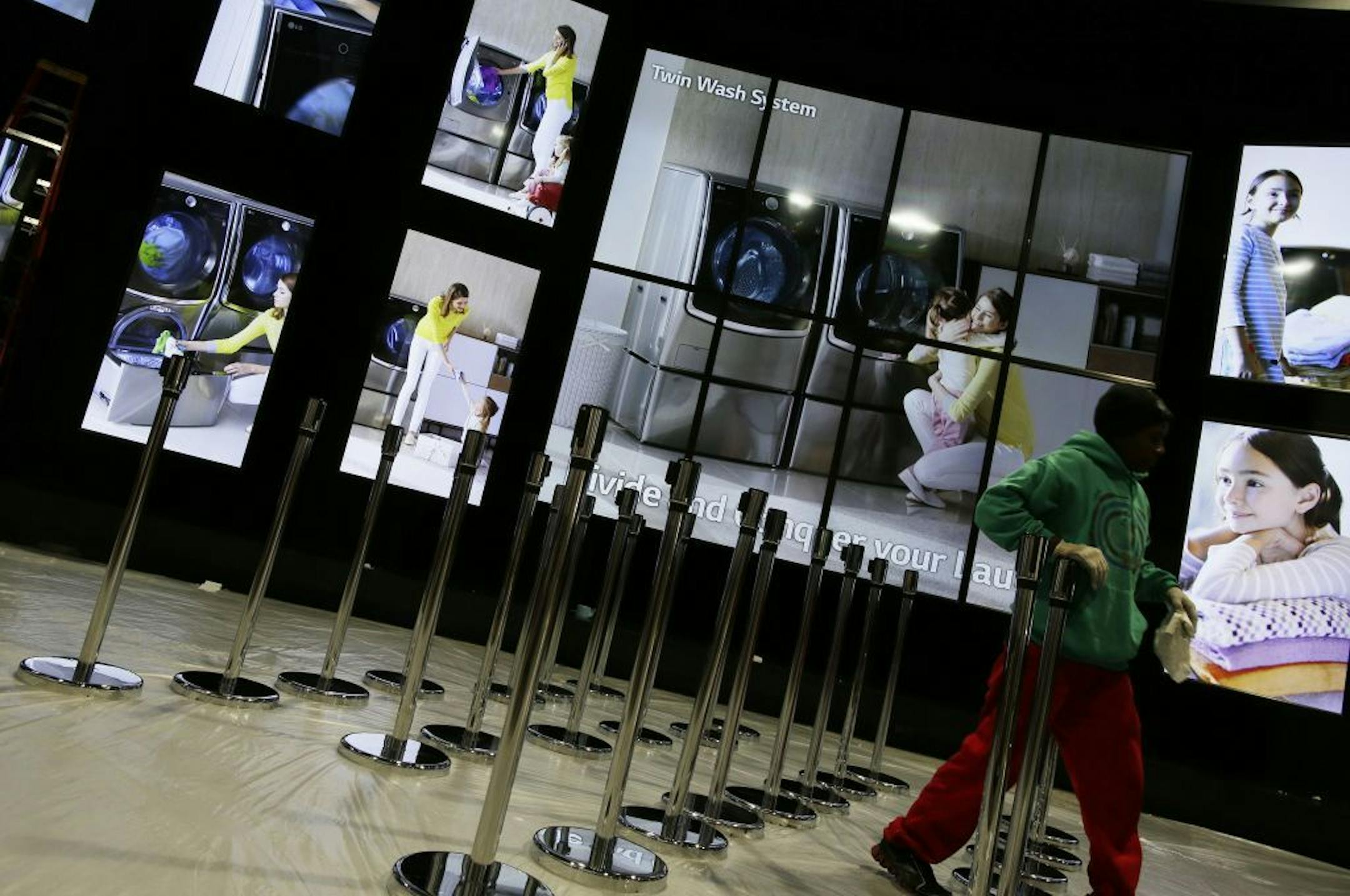 Contractors set up the LG booth at the International Consumer Electronics Show in Las Vegas, Jan. 4, 2015. Household devices that link together through the Internet are likely to energize this year's show in Las Vegas.