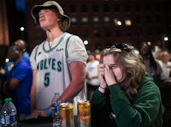 Fans including Sam Haider and Lauren Taylor watched the game unfold at the Wolves Back Block Party near Target Center Thursday night.