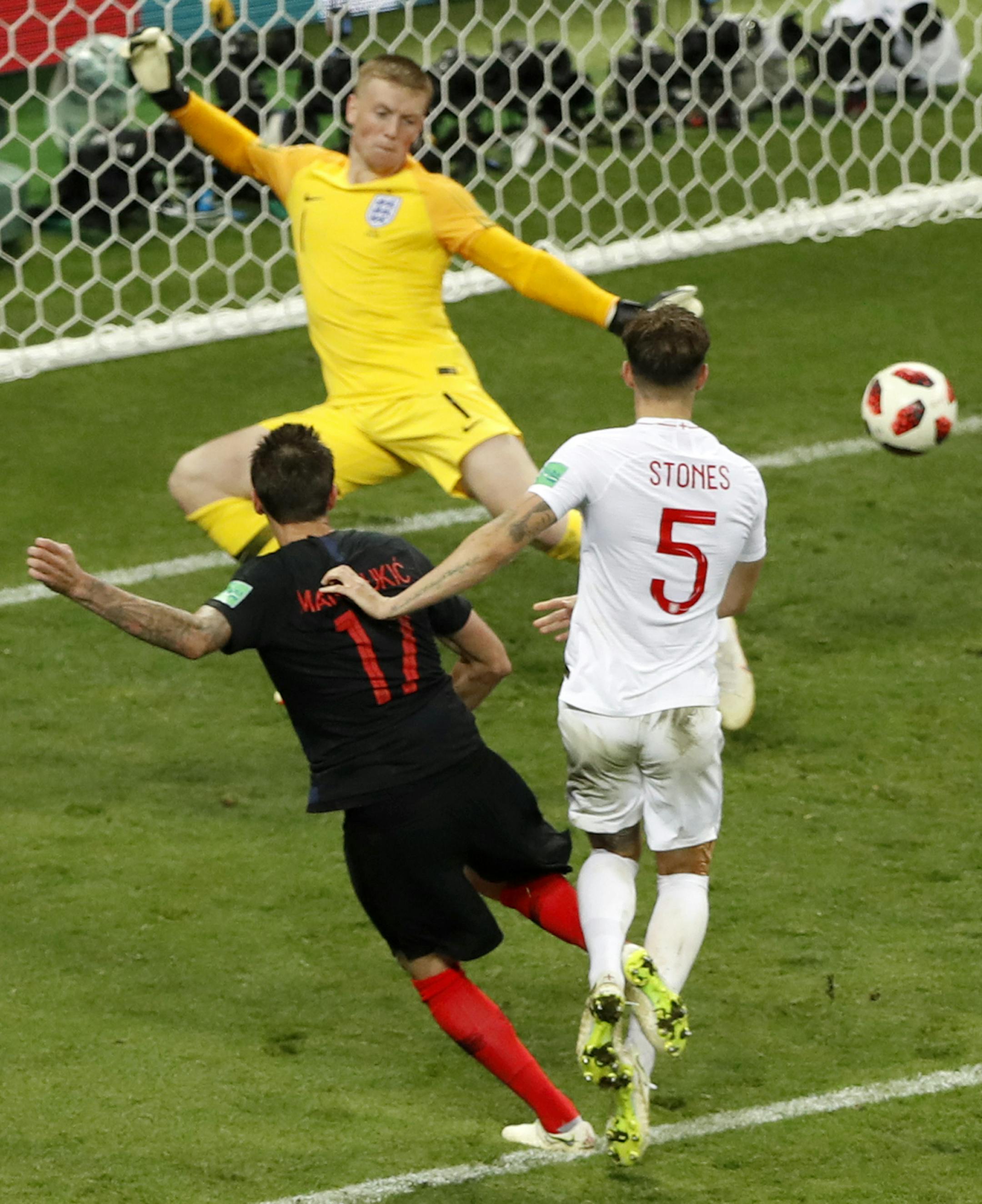 Croatia's Mario Mandzukic, left, scores his side's second goal during the semifinal match between Croatia and England at the 2018 soccer World Cup in the Luzhniki Stadium in Moscow, Russia, Wednesday, July 11, 2018. (AP Photo/Darko Bandic)
