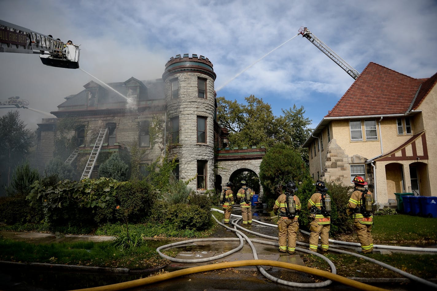 Firefighters battled a fire at a fully engulfed historic home on Dayton Avenue in St. Paul Tuesday.