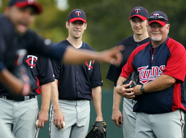 Kevin Slowey, Scott Baker, and Manager Ron Gardenhire watched drills during practice on Monday.