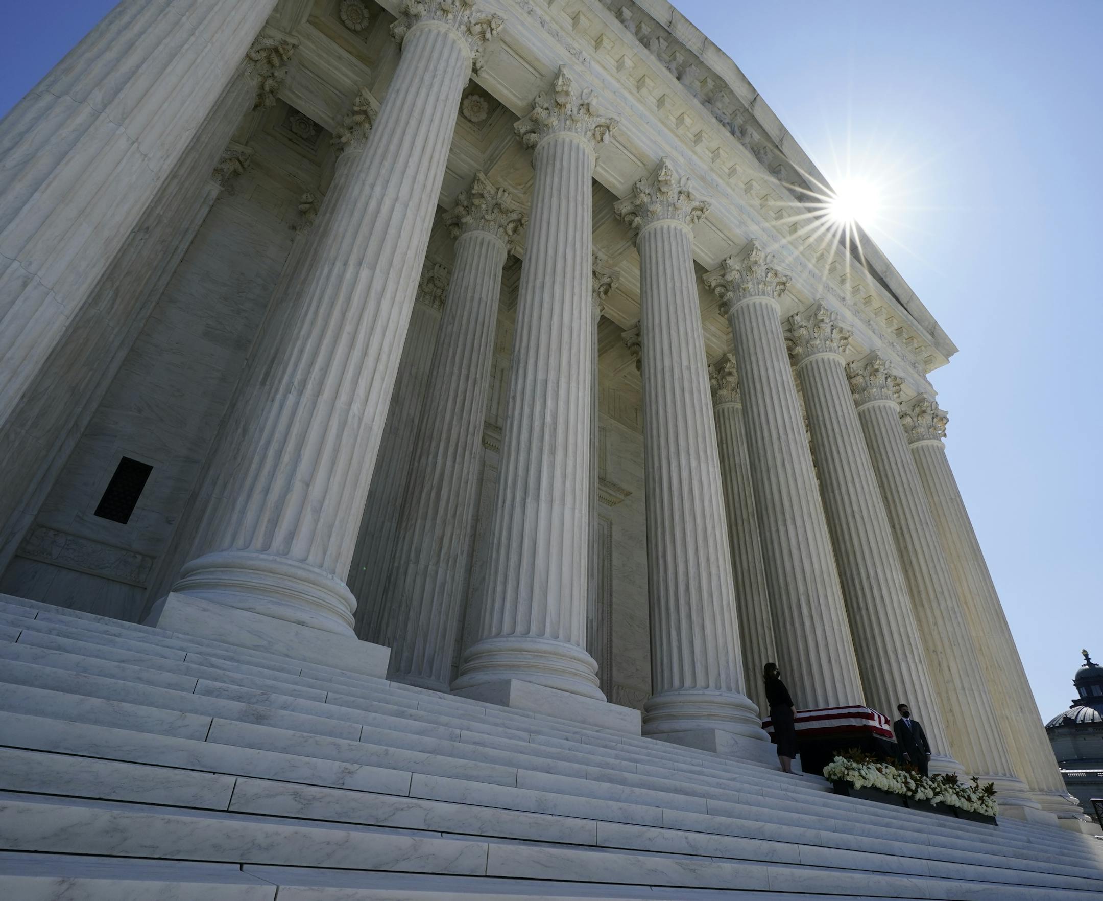 People pay respects as Justice Ruth Bader Ginsburg lies in repose under the Portico at the top of the front steps of the U.S. Supreme Court building on Wednesday, Sept. 23, 2020, in Washington. Ginsburg, 87, died of cancer on Sept. 18. (AP Photo/Alex Brandon, Pool)