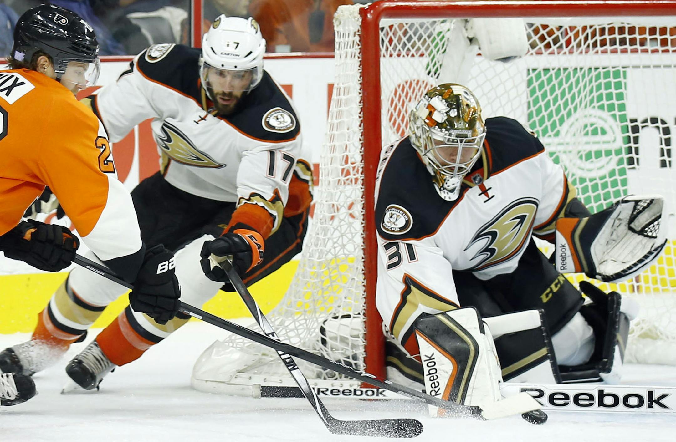 The Philadelphia Flyers' Claude Giroux, left, tries to shoot against Anaheim Ducks goalie Frederik Anderson and Ryan Kesler (17) during the first period on Tuesday, Oct. 14, 2014, at the Wells Fargo Center in Philadelphia. (Yong Kim/Philadelphia Daily News/MCT)