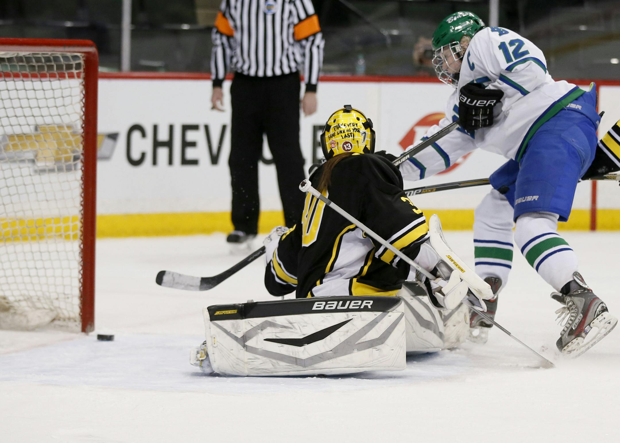 Karlie Lund of Blake scored her third goal of the game as she shoots passed Hutchinson goal keeper Ellie Lenarz in the second period. Blake played Hutchinson in the Class 1A hockey quarterfinals at Xcel Energy Center Wednesday February 18, 2015 in St. Paul, MN. ] Jerry Holt/ Jerry.Holt@Startribune.com