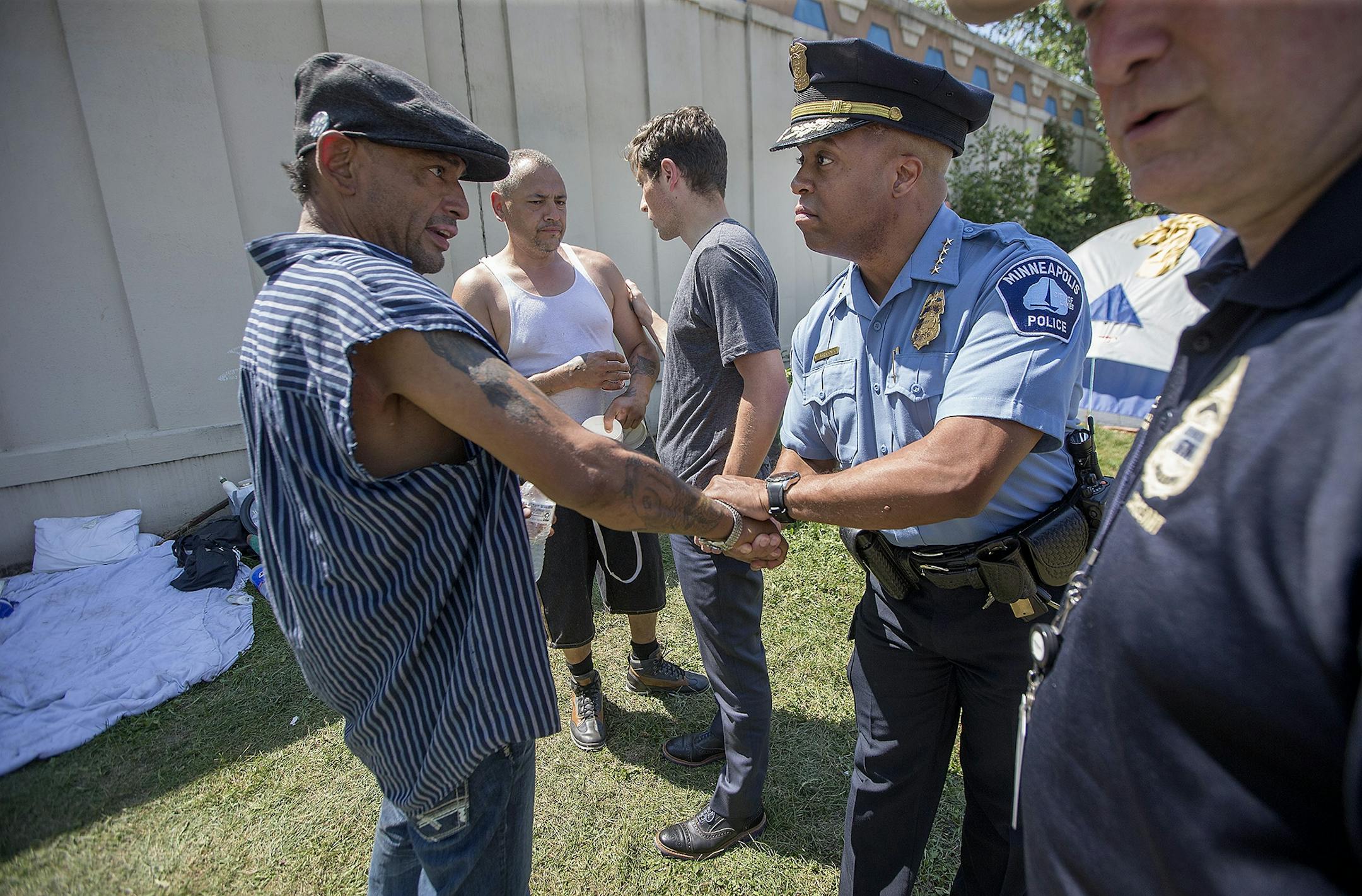 Minneapolis Police Chief Medaria Arradondo, center, Minneapolis Mayor Jacob Frey, left, and Minneapolis Police Sgt. Grant Snyder, right, visited a homeless encampment near 16th Avenue South & East Franklin Avenue Wednesday, August 8, 2018 in Minneapolis, MN.