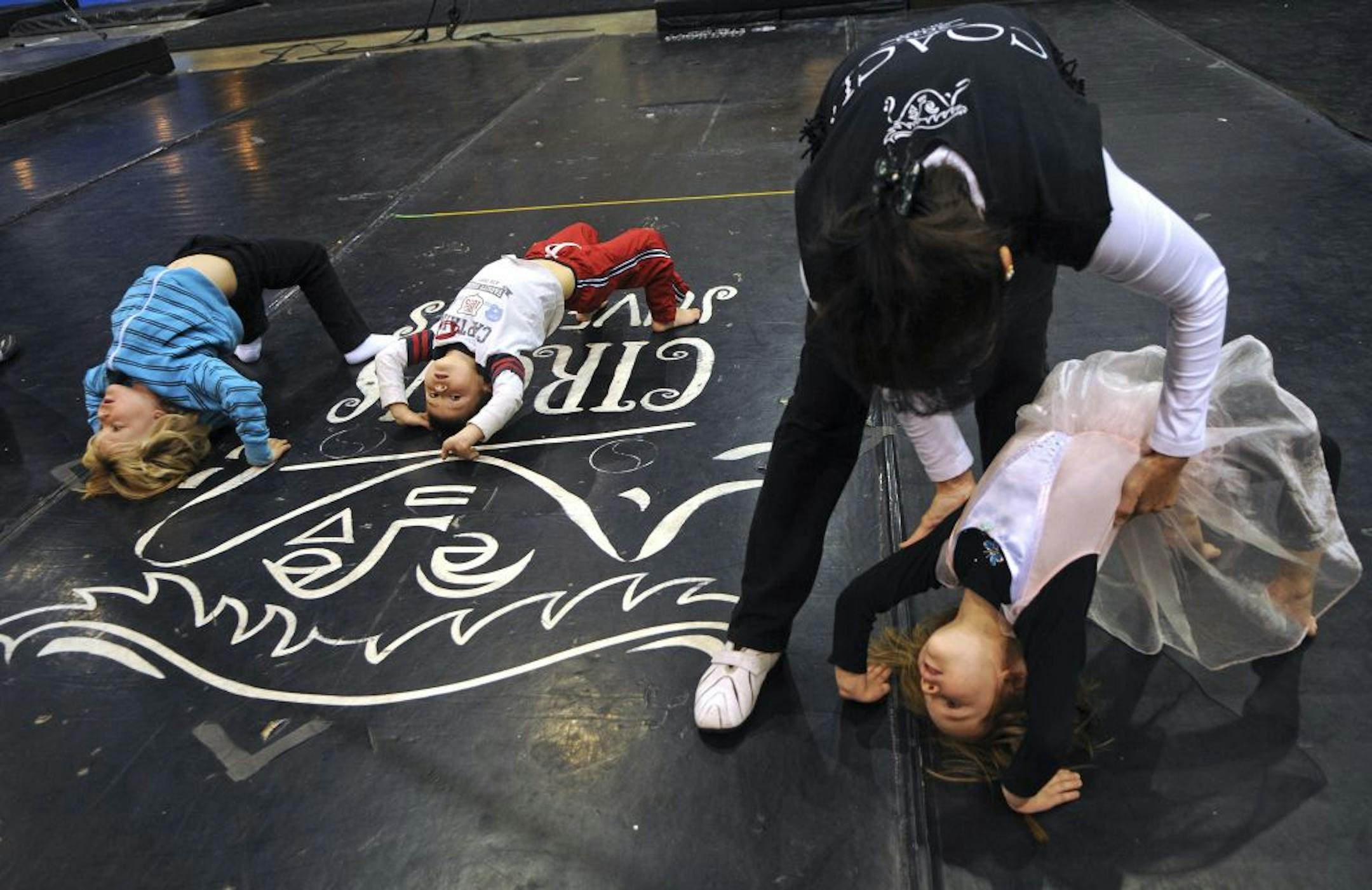 Minnesota nonprofits put on a show Wednesday to drum up donations for the third annual Give to the Max Day. Coach Chim Gee helped Sage Skally, 3, of St. Paul stretch out before the circus school at Circus Juventas, which hosted a "cirque-a-thon" under its big top in St. Paul during the fundraising blitz.
