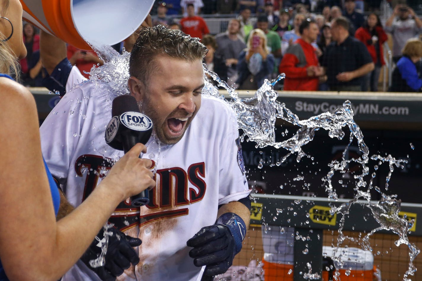 Minnesota Twins' Brian Dozier receives a bucket of water over his head during an interview after he hit a two-run home run to defeat the Miami Marlins 6-4 in 11 innings in a baseball game Tuesday, June 7, 2016, in Minneapolis. (AP Photo/Bruce Kluckhohn) ORG XMIT: MNBK113