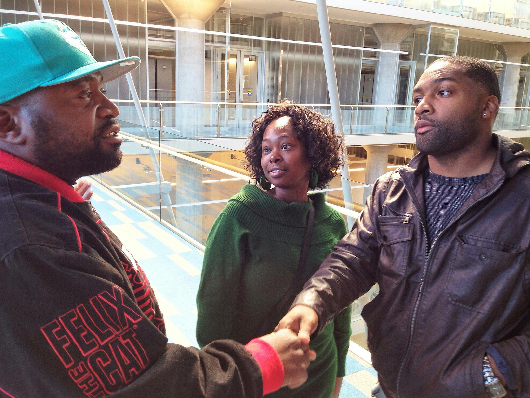 Levi Bradley - 'agent121813' - right - Levi Bradley, right, interacts with high school football parents Jeff Jones Sr., left, and Tasha Harmon. Bradley is a mentor and advocate in the lives of their sons, Washburn standout Jeff Jones Jr. and Chanhassen standout Raymonte Maynard.