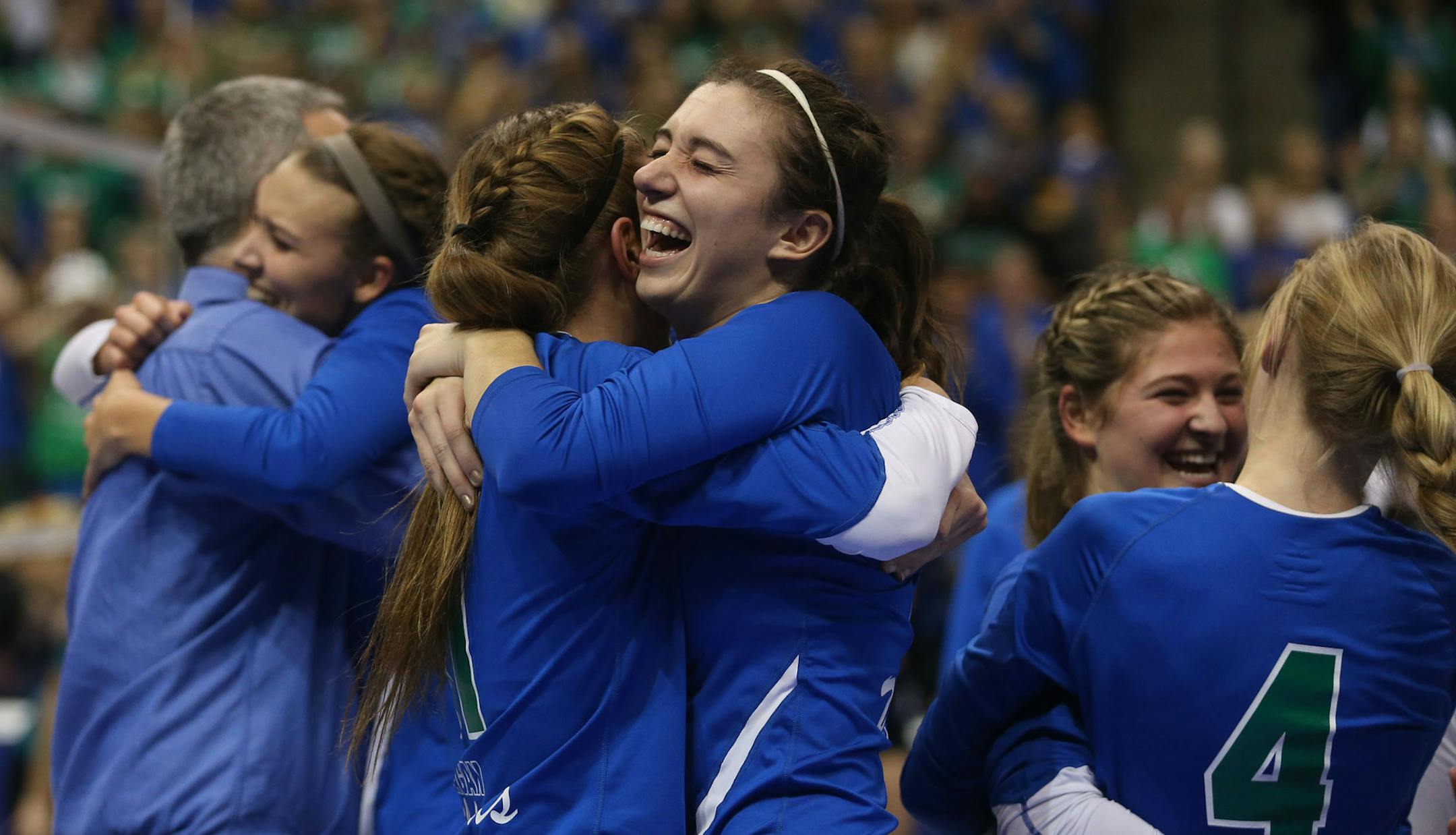 Eagan's Callie Schapekahm, left, hugged teammate Celia Bertsch after winning the state championship Class 3A finals at the Xcel Energy Center in St. Paul, Min., Saturday, November 9, 2013. Eagan won over Delano 3-2. ] (KYNDELL HARKNESS/STAR TRIBUNE) kyndell.harkness@startribune.com ORG XMIT: MIN1311091945510087