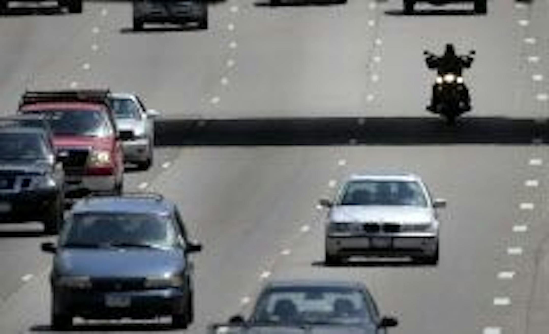 FILE -- Seen from the 40th Street pedestrian bridge, a motorcylcist is sihlouetted beneath the 42nd Street Bridge while traveling north along I-35W, Friday, June 6, 2014, just south of downtown Minneapolis, MN.