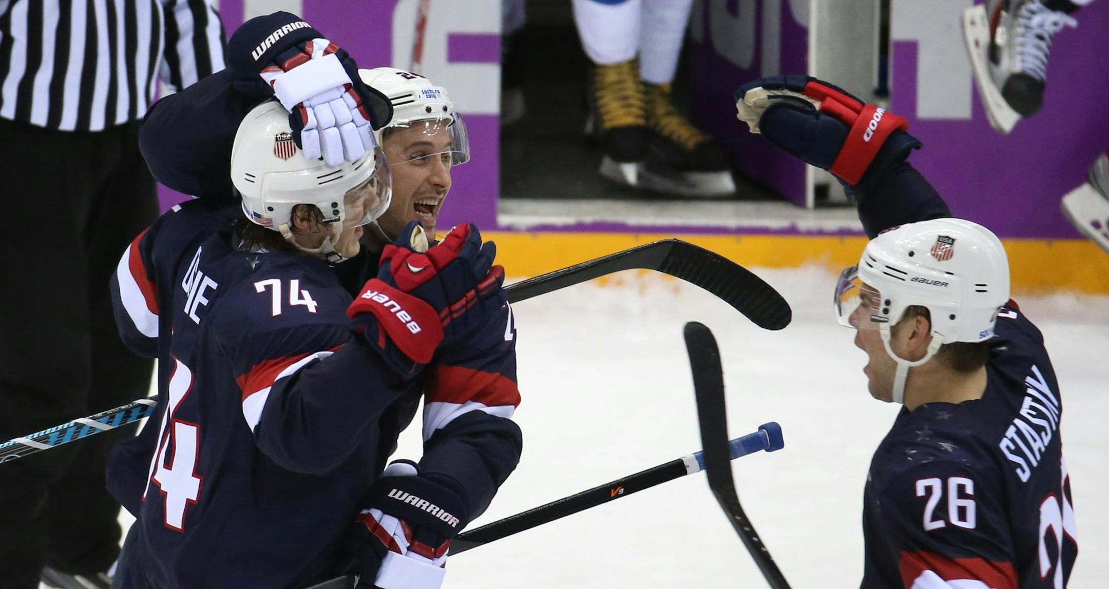 Team USA mobs forward T.J. Oshie (74) after he scored to win a shootout against Russia in a men's hockey game at Bolshoy Ice Dome during the Winter Olympics in Sochi, Russia, Saturday, Feb. 15, 2014. USA defeated Russia, 3-2. (Brian Cassella/Chicago Tribune/MCT)