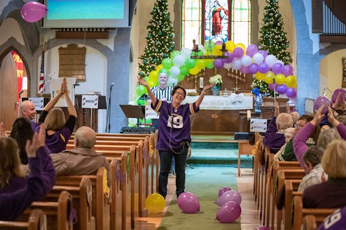 With the church covered in purple, green, and yellow balloons, Pastor Vicki VanderVegt led parishioners in Skol Vikings at the end of the service.