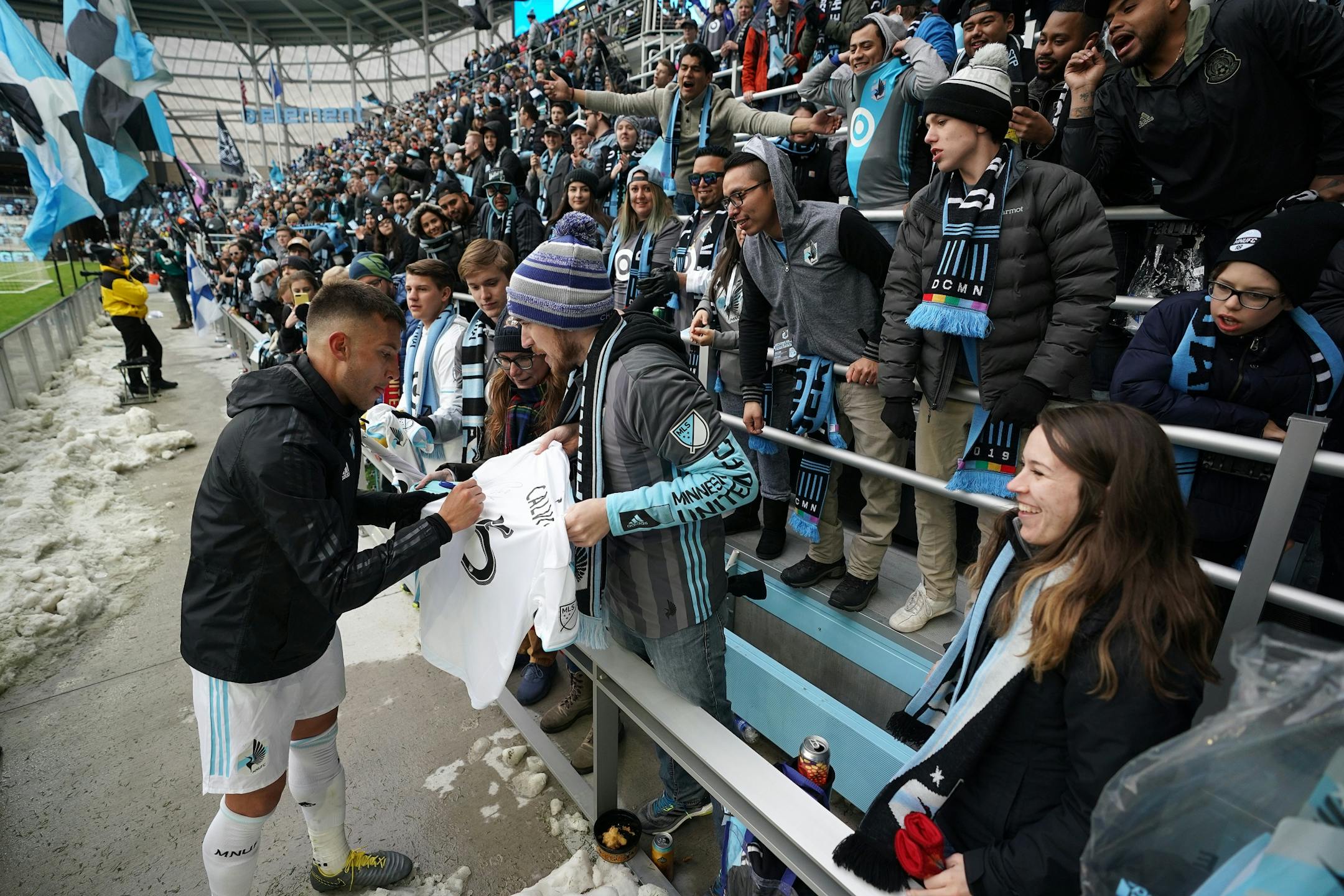 Minnesota United midfielder Osvaldo Alonso (6) signed an autograph for Joe Lewis of Cottage Grove after the tie at the end of the second half.