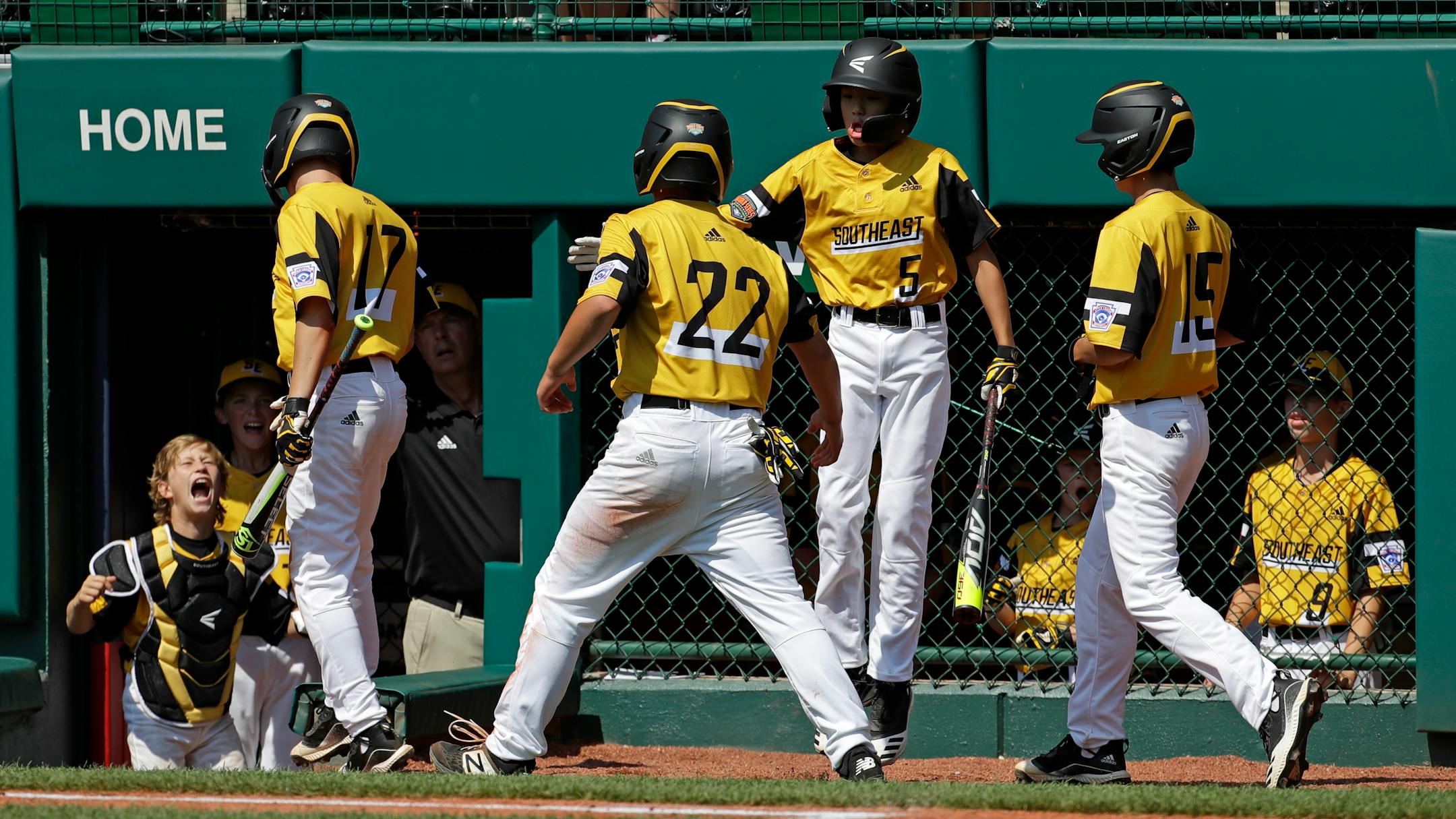 South Riding, Virginia catcher Noah Culpepper, left, welcomes Chase Obstgarten (17), Justin Lee (22), and Brady Yates (15) after they scored on a bases loaded double by Liam Thyen off Coon Rapids, Minnesota pitcher Drew Law during the first inning of a baseball game at the Little League World Series tournament in South Williamsport, Pa., Sunday, Aug. 18, 2019. Virginia won 11-0. (AP Photo/Gene J. Puskar)