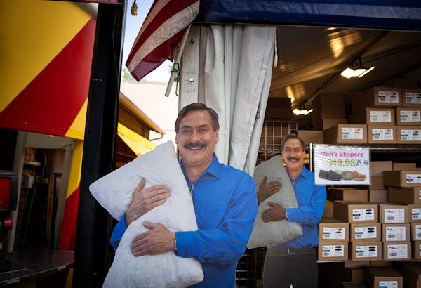 Cardboard cutouts of Mike Lindell hawked MyPillow products at the Minnesota State Fair on Aug. 30. “I would never settle in any lawsuit,” he said 