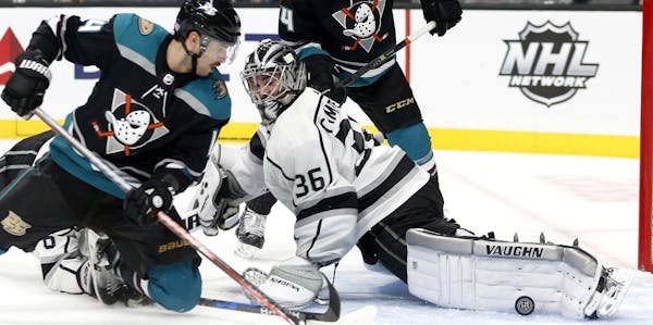 Los Angeles Kings goalie Jack Campbell (36) stops a shot by Anaheim Ducks forward Adam Henrique (14) during the third period of an NHL hockey game Tue