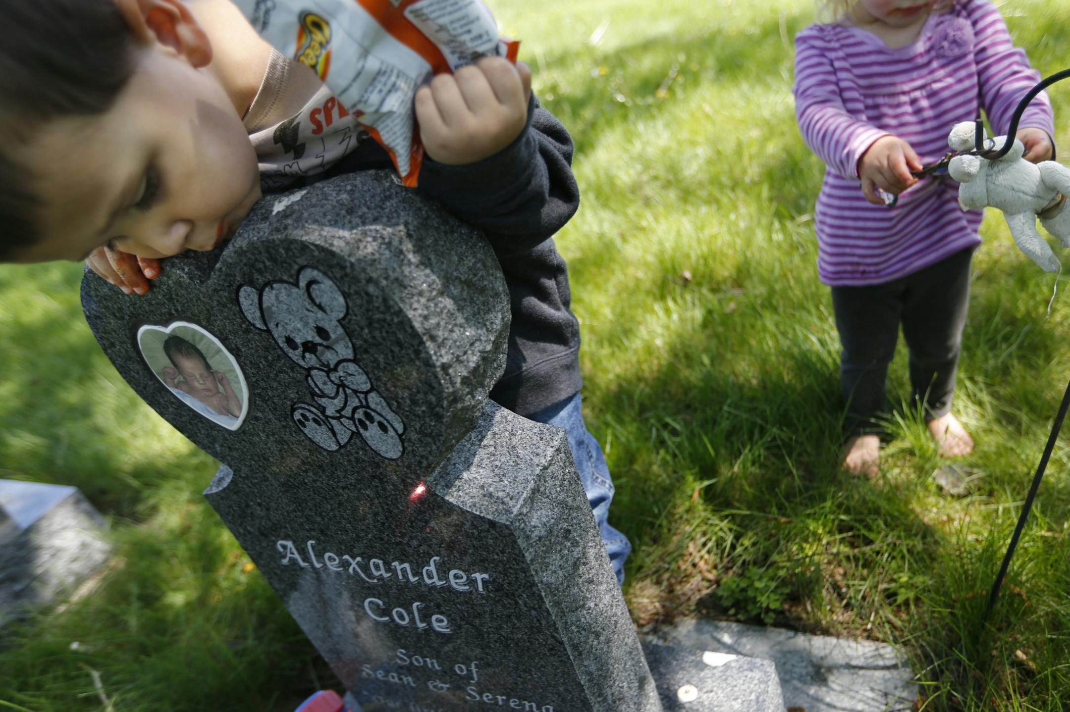 Sylar Gragert, 3, looked at gravestone of his brother, Alexander, who was 7 weeks old when he died of SIDS in day care. No charges were filed, but Serena Gragert wonders whether the former "day-care lady" was too busy with other kids to monitor her son. Nobody had checked on him for 90 minutes before he was found not breathing.