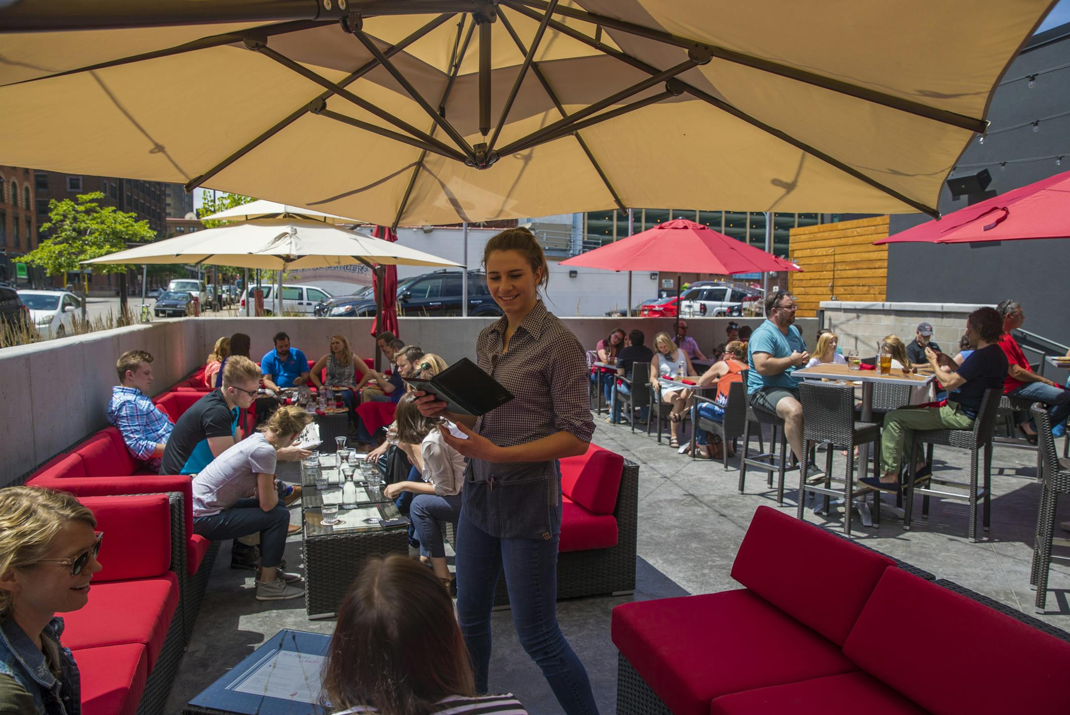 Server Annie Thompson took an order on the patio at the Red Rabbit in Minneapolis, Minn., on Friday, June 16, 2017. ] RENEE JONES SCHNEIDER • renee.jones@startribune.com