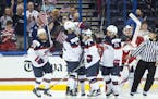 United States players celebrate a goal during the third period of the Four Nations Cup championship hockey game against Canada in Tampa, Fla., Sunday,