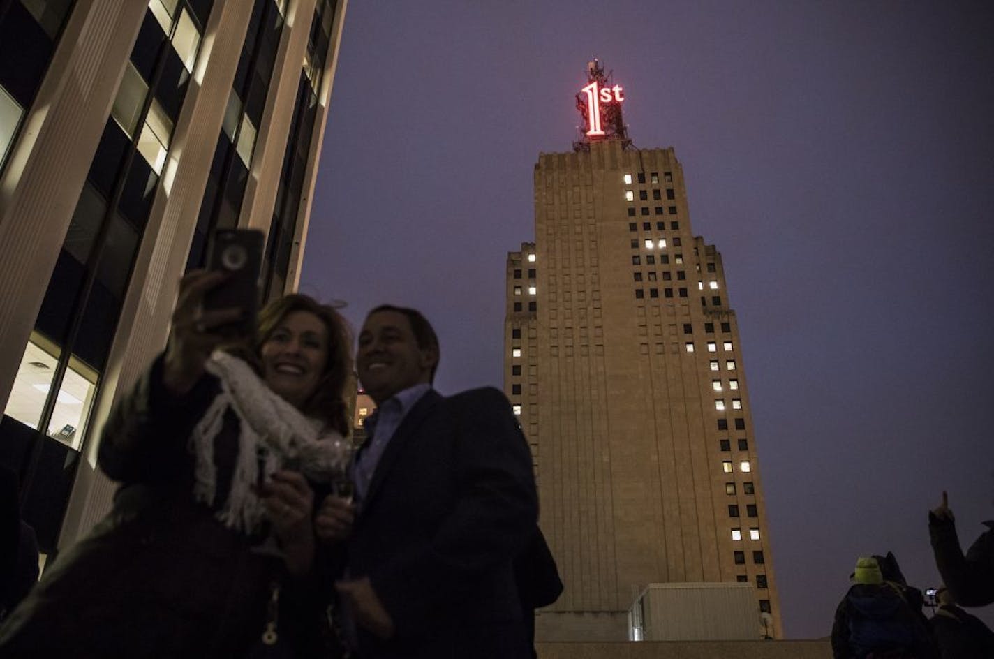 Ronn (CQ) and Cathy Jansen, on a rooftop at the neighboring US Bank Building, took a selfie at the re-lighting of the iconic First National Bank Building red "1st" sign on Tuesday, November 22, 2016, in St. Paul, Minn.