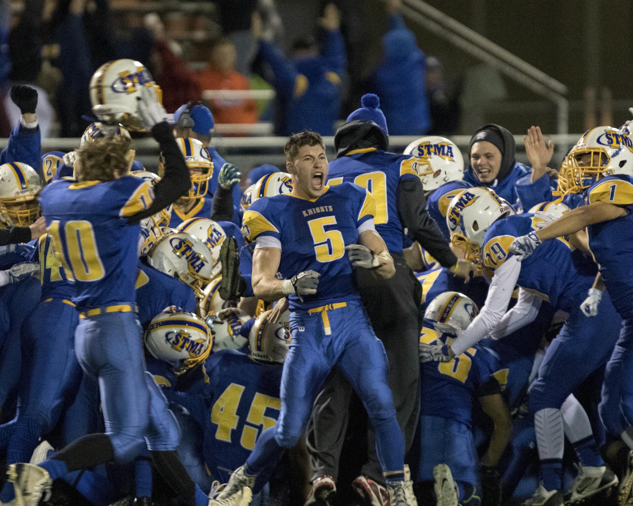 St. Michael-Albertville linebacker Coltan Koenig (5) and the Knights celebrate the game winning field goal by rushing the field as time expires as the Spring Lake Park Panthers faced the St. Michael-Albertville Knights in the Class 5A MSHSL Football playoffs. ] MATT BLEWETT &#xef; matt@mattebphoto.com - October 31, 2015, Osseo, MN, Spring Lake Park Panthers, St. Michael-Albertville Knights, Prep Football, Spring Lake Park Panthers vs St. Michael-Albertville Knights, 264495 PREP110115