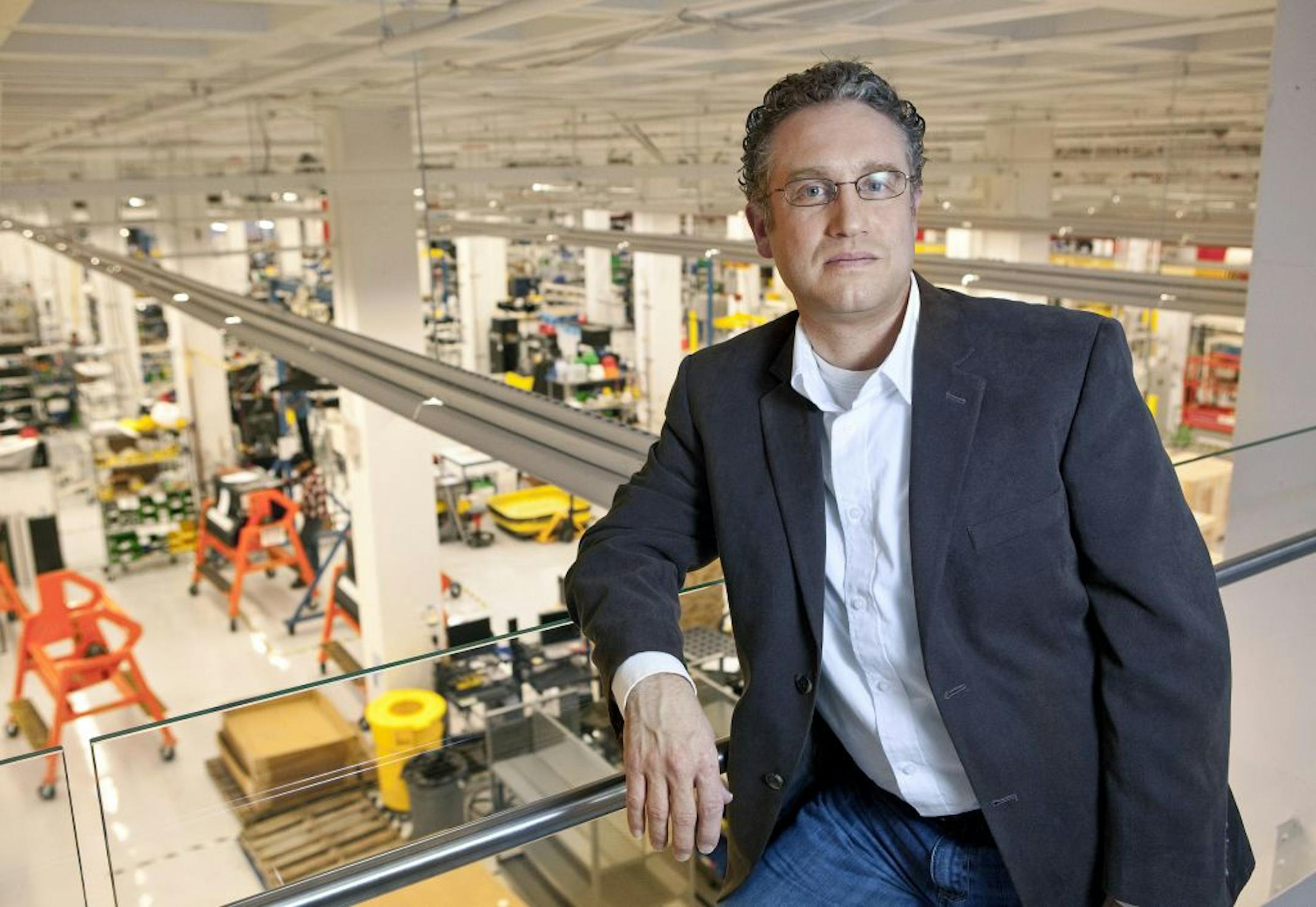 Arnnon Geshuri, the vice president of Human Resources at Tesla Motors in Fremont, California, looks out over the manufacturing floor at the Tesla facility on November 29, 2011. Tesla is ramping up hiring to manufacture its all-electric Model S sedan at the plant.