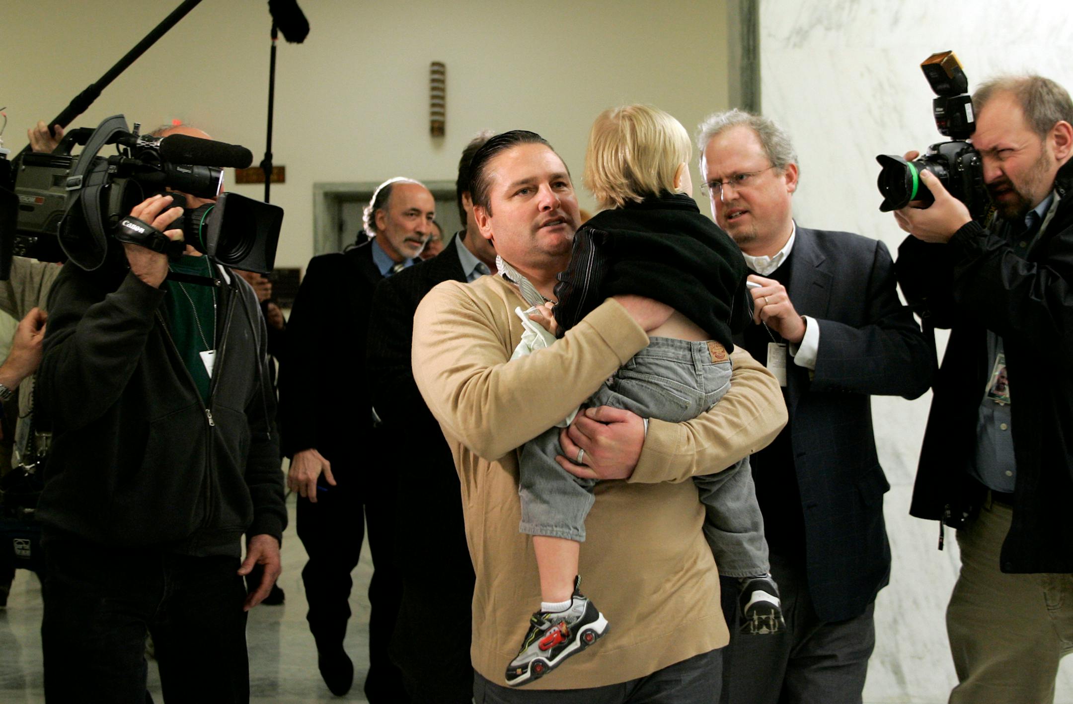 Chuck Knoblauch, holding his son, Jake, left Capitol Hill on Friday after giving closed-door testimony about steroids in baseball. Knobby explained that the trip was a learning experience for Jake.