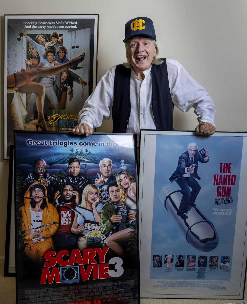 Writer Pat Proft photographed with movie posters from some of the films he has worked on.